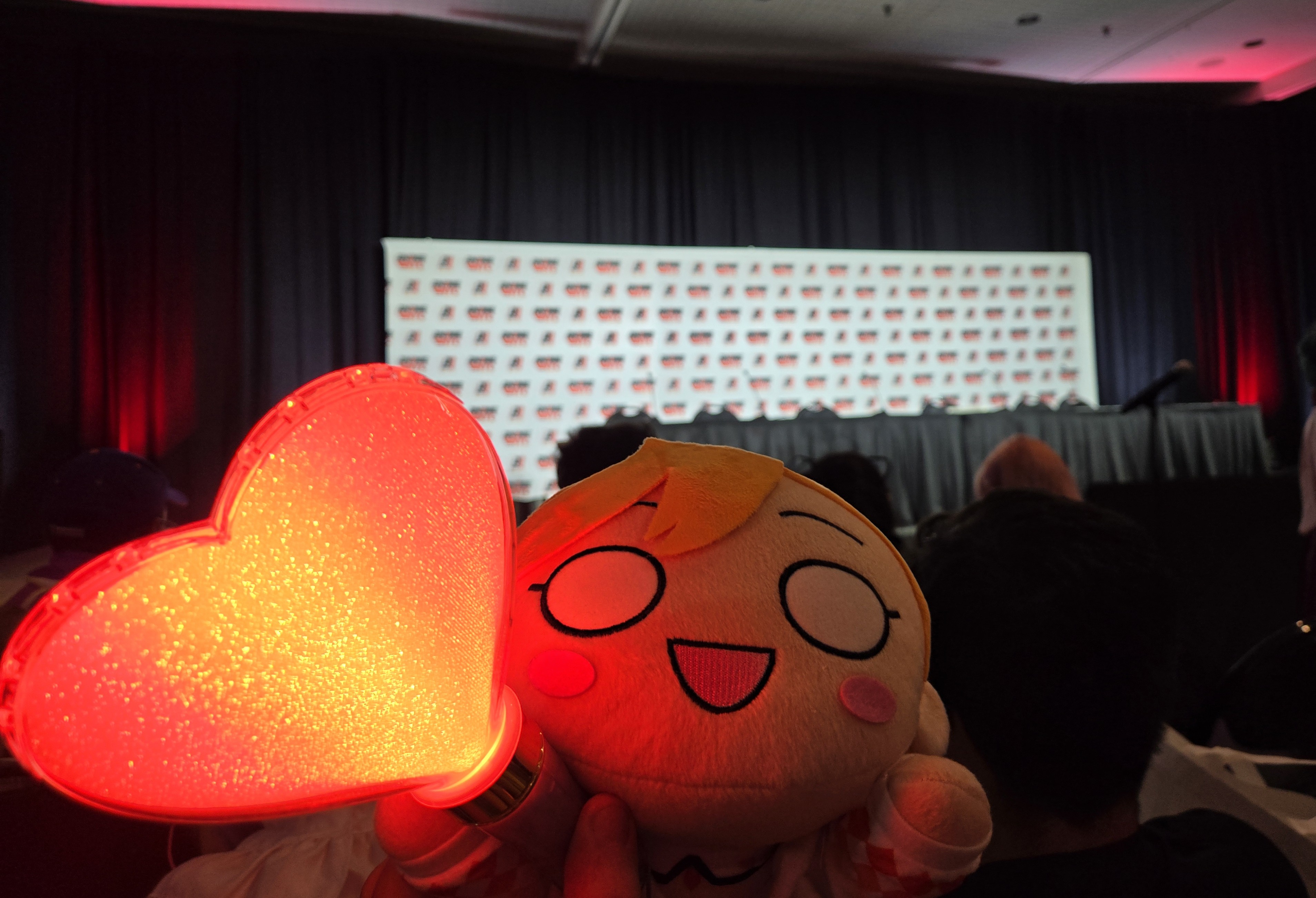 A photo from my seat for CatChu!'s panel, with my Kanon-chan nesoberi and heart-shaped penlight!