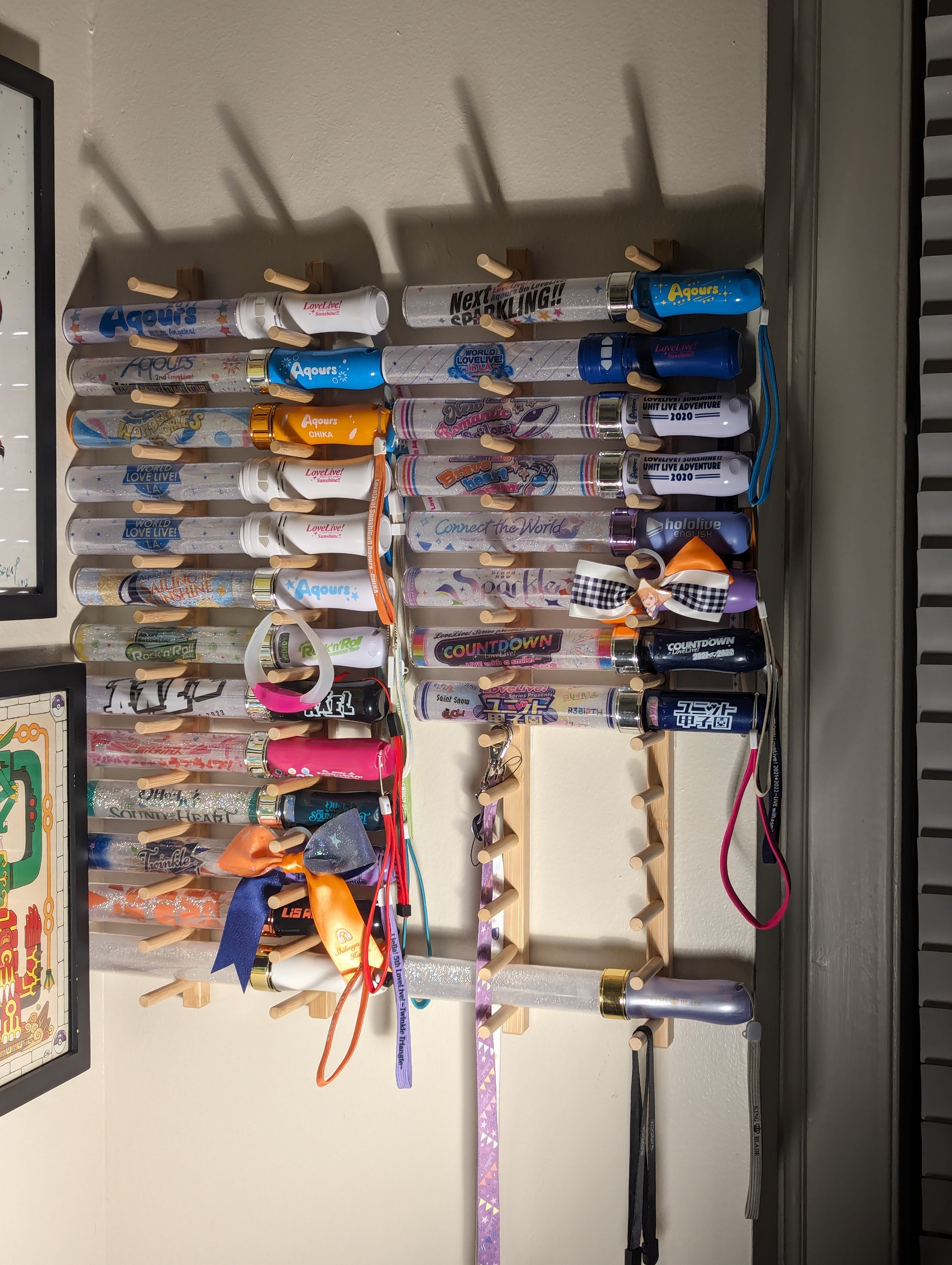 A collection of Japanese Concert Penlights, mounted to a wall.